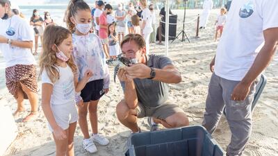 Young children were among the crowd that gathered to watch the turtle being released.