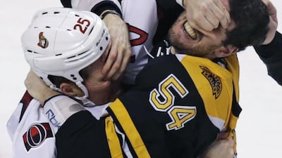 Ottawa Senators right wing Chris Neil (25) and Boston Bruins defenseman Adam McQuaid (54) gouge each other’s eyes as they fight during the third period of a NHL hockey game. Charles Krupa / AP Photo