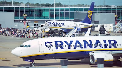 Passengers queue to board Ryanair aircraft at Stansted Airport, in south-east England. The airline is adding 500 flights from Stansted. PA