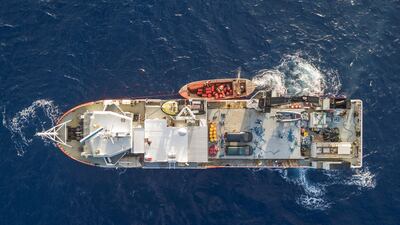 Bravo Supporter, the Pitcairn supply ship loads supplies onto a Pitcairn long boat. Iain McGregor/STUFF