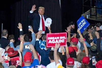 Former US President and Republican presidential candidate Donald Trump waves as he walks on stage during a campaign rally in Virginia on November 2. AFP