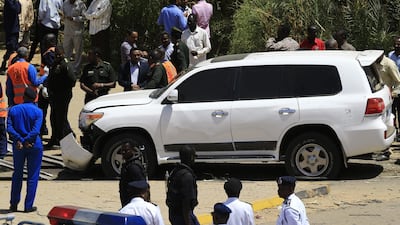 Sudanese rescue teams and security forces gather next to a damaged vehicle at the site of an assassination attempt against Sudan's Prime Minister Abdalla Hamdok, who survived the attack with explosives unharmed, in the capital Khartoum. AFP