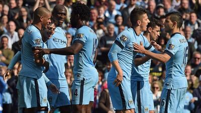 Manchester City players celebrate after one of their goals on Saturday in their Premier League win over West Brom. Paul Ellis / AFP / March 21, 2015
