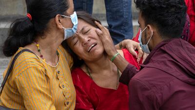 Relatives of victims are overcome by grief outside the hospital mortuary. EPA