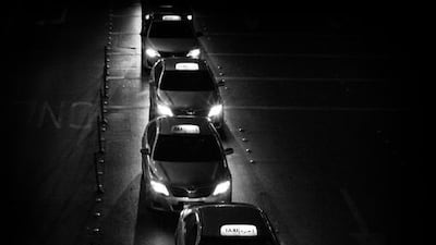 Taxis overflow from the taxi stand into the street in front of Abu Dhabi Mall, while waiting for customers. Brian Kerrigan / The National