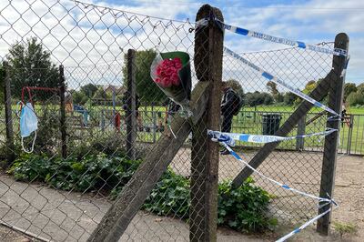 Floral tributes left at the entrance to the playing field in Craneford Way, Twickenham. PA