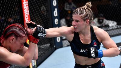 Miranda Maverick punches Gillian Robertson of Canada in their lightweight fight during the UFC 260 event at UFC APEX in Las Vegas, Nevada. Jeff Bottari / USA TODAY Sports / Reuters