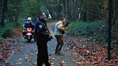 Members of the police animal brigade walk through a wood in Montevrain, east of Paris, on November 13, 2014. Thibault Camus / AP Photo