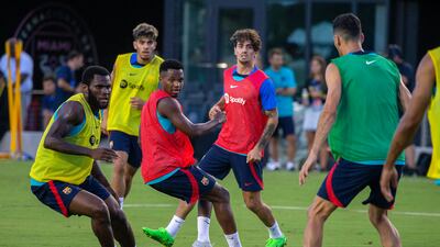 Ansu Fati, Frank Kessie and Sergio Busquets during Barcelona's open training at the DRV PNK Stadium. EPA