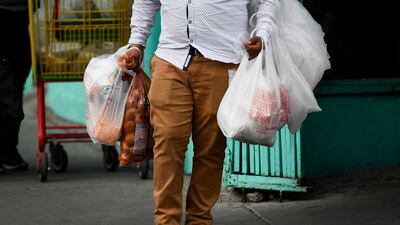A shopper carries groceries from a store in El Paso, Texas. AFP