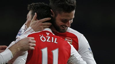Arsenal’s Mesut Ozil celebrates with Olivier Giroud during their Premier League win against Bournemouth on Monday night. Adrian Dennis / AFP