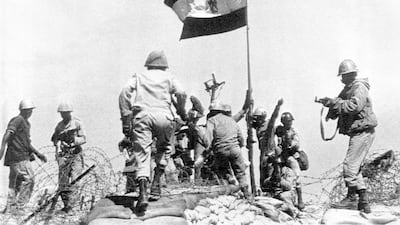 Egyptian troops celebrate as they plant their flag atop a bunker on Bar-Lev line east of Suez Canal, Oct. 13, 1973. (AP Photo/Pool/Ahmed Tayeb)