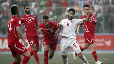 Palestinian player Haytham Theeb, centre, vies for the ball with the UAE’s Majed Hassan, second right, during their 2018 World Cup qualifier at the Faisal al-Husseini Stadium, on September 8, 2015 in the West Bank town of Al-Ram. Thomas Coex / AFP