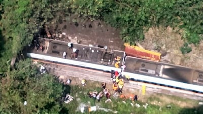 In this photo released by National Fire Agency, rescue workers are seen near the site of a partial train derailment in Toroko Gorge in Taiwan's eastern Hualien region. AP