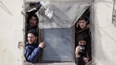 Israeli settlers barricade themselves in their house as Israeli security forces arrive to the illegal Jewish settlement of Amona, in the West Bank. Abir Sultan / EPA