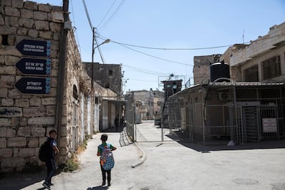 Palestinian children enter a checkpoint in the divided West Bank city of Hebron on September 27,2018. Photo by Heidi Levine for The National
