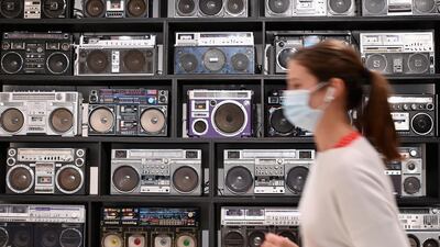 An employee walks past The Wall of Boom by DJ Ross One, an art installation featuring 32 vintage boomboxes as a working sound system displayed during a press preview at Sotheby's for their hip-hop auction. AFP