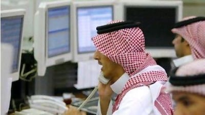 Saudi stock traders take orders. The Tadawul All-Share Index rose on the back of a spending package announced by the Saudi king.