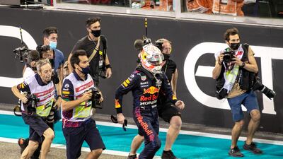 Verstappen runs to celebrate with his team. Victor Besa / The National