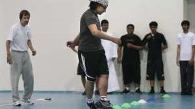 Tim March, left, the general manager of the Sharjah Football Club, puts students through their paces as part of a new health and fitness programme.