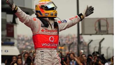 Lewis Hamilton celebrates in front of the world's media after winning yesterday's Chinese Grand Prix.
