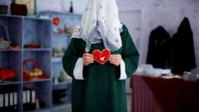 Shama, 19, an inmate at Al Wathba Central Prison, shows a piece of art she made in the workshop.