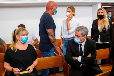 Bar Refaeli, centre right, her mother, Tzipi, left, her father, Raffi, centre left, and lawyers, at a courtroom in Tel Aviv on Monday. AFP