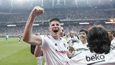 Besiktas striker Mario Gomez celebrates with teammates after their win on Sunday clinched the Turkish Super Lig title for the club. Sedat Suna / EPA / May 15, 2016