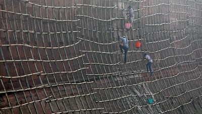 Workers climb scaffolding to clean the walls of the historic Red Fort in the old quarters of Delhi, India. Saumya Khandelwal / Reuters.