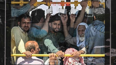 Commuters travel on an overcrowded public bus in Islamabad, Pakistan. State-run public transport in the capital city and province is free throughout April, after Pakistan's government drastically raised fuel prices due to the Iran war. AFP