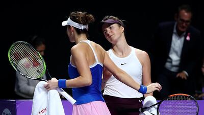 Belinda Bencic, left, is consoled by Elina Svitolina after her retirement during the WTA Finals semi-final. Getty Images