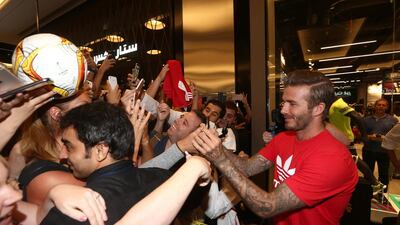 Former Manchester United player David Beckham, shown here signing autographs as he opened the new adidas store in Dubai, got the backing for a new MLS stadium project from the league's board of governors. (Photo by Warren Little/Getty Images)