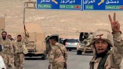 Forces loyal to Syrian president Bashar Al Assad gesture as they advance into the historic city of Palmyra in this picture provided by SANA on March 24, 2016. SANA/Handout via Reuters