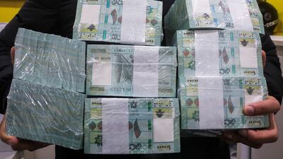A money exchange vendor displays Lebanese pound banknotes in Beirut. The IMF programme is the 'only viable way out of the acute and unprecedented crisis', ABL said. Reuters
