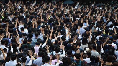 Pro-democracy demonstrators hold up their hands to symbolise their five demands at Chater Garden in Hong Kong. AFP