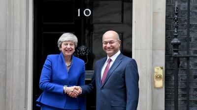 Britain’s Prime Minister Theresa May shakes hands with Iraq’s President Barham Salih in London on Tuesday. Reuters