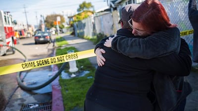 Mourners gather near a warehouse after it was destroyed by a fire in Oakland, California. Up to 40 people were feared dead the blaze. Nick Otto / AFP Photo