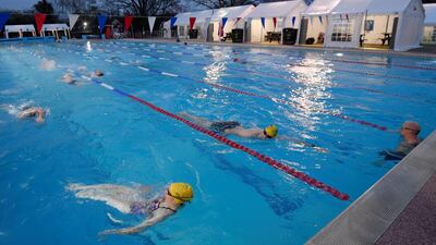 Swimmers train in Hampton Lido in London on the first day that outdoor pools are allowed to open. Reuters