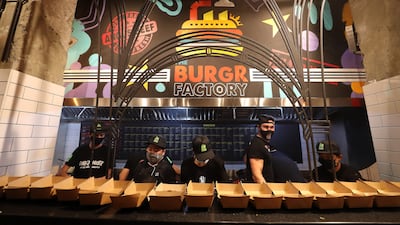 Staff preparing burgers at The Burgr Factory during its launch. Pawan Singh/The National