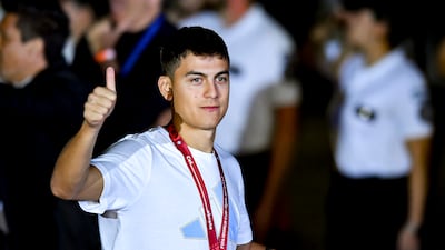 Argentina attacker Paulo Dybala greets the fans on arrival at the airport. Getty