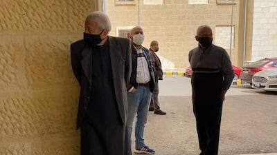 Families of the victims wait outside the morgue to collect the bodies of their loved ones.