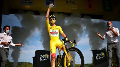 Slovenian rider Tadej Pogacar of the UAE Team Emirates, bearer of the Yellow T-shirt waves from the podium before the start of the 21st and last stage of the Tour de France 2020 cycling race over 122km from Mantes-La-Jolie to Paris, France. EPA