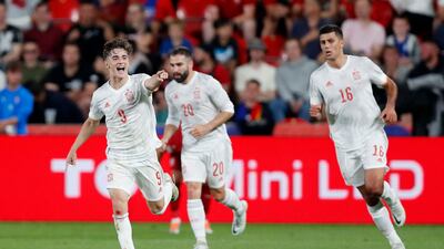 Gavi celebrates scoring Spain's first goal with Rodri and Dani Carvajal. Reuters