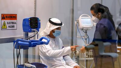 A volunteer has his heart rate checked after registering to take part in the Covid-19 clinical trial in Abu Dhabi. Victor Besa / The National