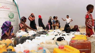 Yemenis fill jerrycans with water at a makeshift camp in the district of Abs, in Yemen's northwestern Hajjah province. AFP