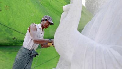 A man sculpts marble stones into a Buddha statue at a marble mine at Zagyin village. Soe Zeya Tun / Reuters