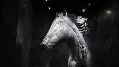 A tour guide admires the statue of renowned racehorse Dubai Millennium. The artwork at Vision Pavilion in Expo City, Dubai, is made from marble imported from Spain and weighs 52 tonnes. Chris Whiteoak / The National