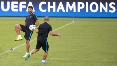 Barcelona's Luis Suarez plays a pass during a training session on Tuesday ahead of the team's Champions League opener on Wednesday against AS Roma. Claudio Peri / EPA