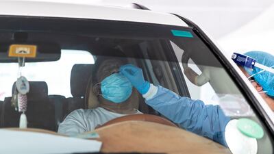 A motorist is tested at Seha’s drive-through centre in Ras Al Khaimah .
