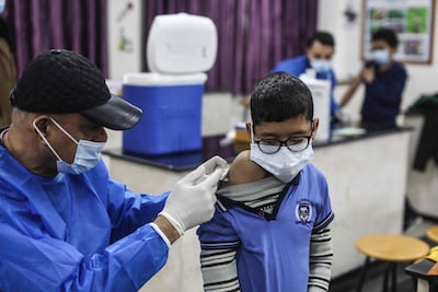 A Palestinian pupil receives a dose of the Pfizer-BioNTech vaccine against Covid-19 at a school in Gaza's Al Shati refugee camp. AFP